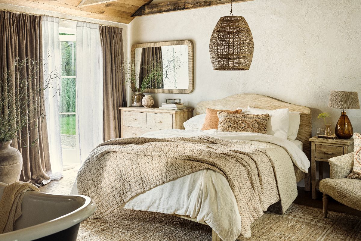 A spring bedroom design with rustic textures, wood panelling, rattan lighting, wood furniture and soft furnishings made from natural materials.