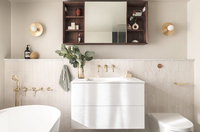 A white bathroom design with zellige wall tiles and neutral paint, and terrazzo flooring.