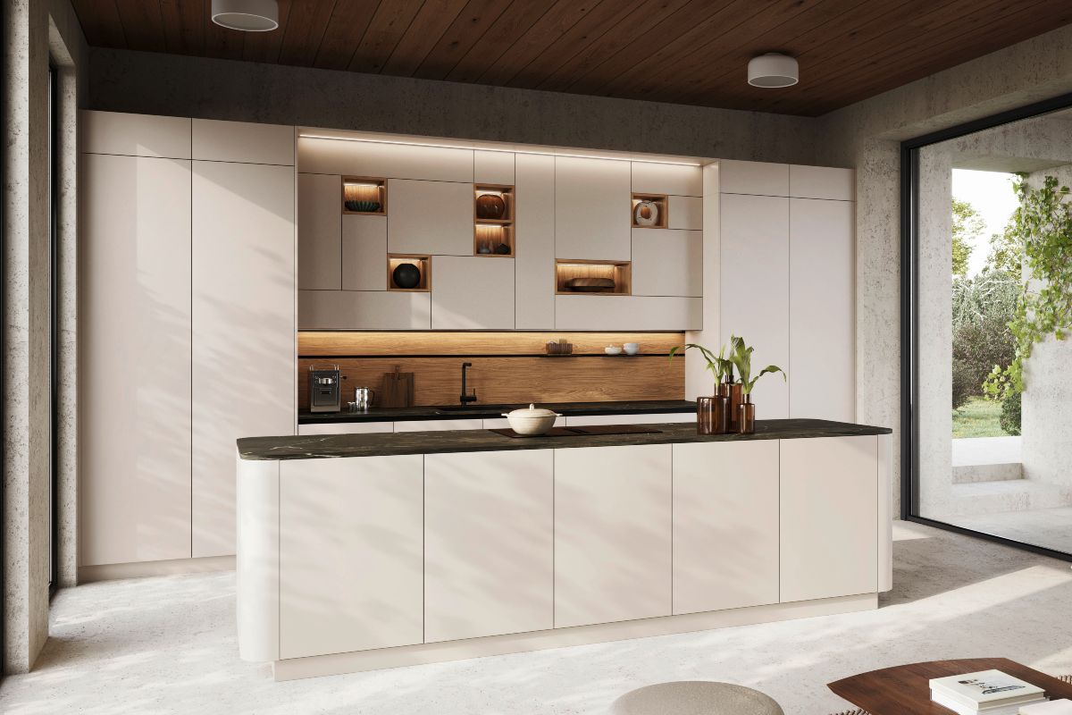 A neutral kitchen design with handleless units, curved island, and wood accents.
