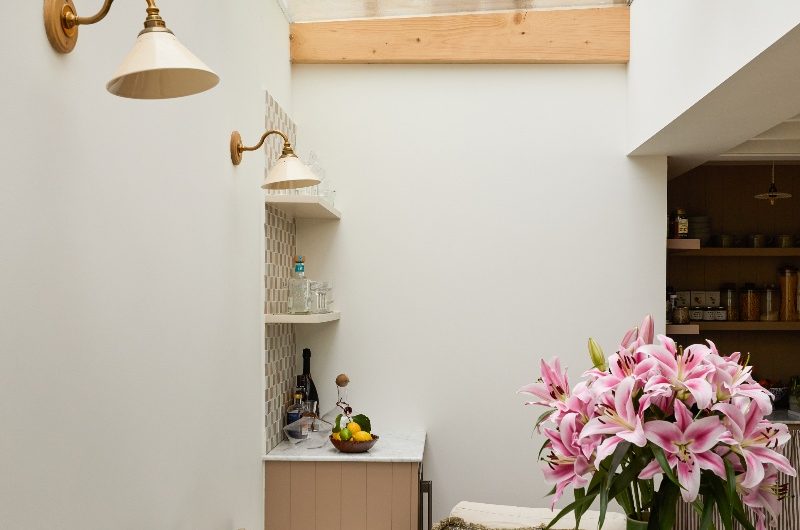 View of the dining area with a storage bench and bar area, and a glass roof.