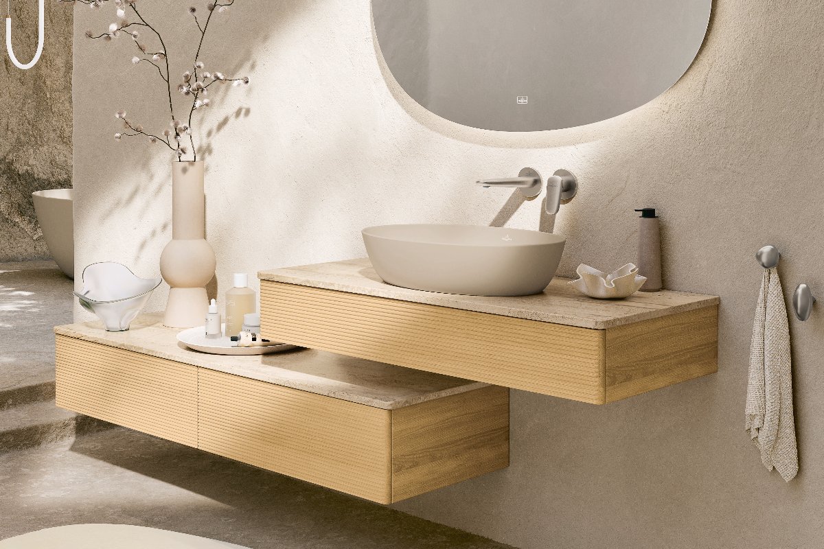 A calm bathroom with tactile wall cladding, wall-mounted fluted vanity, a neutral countertop basin, and sleek modern fittings.