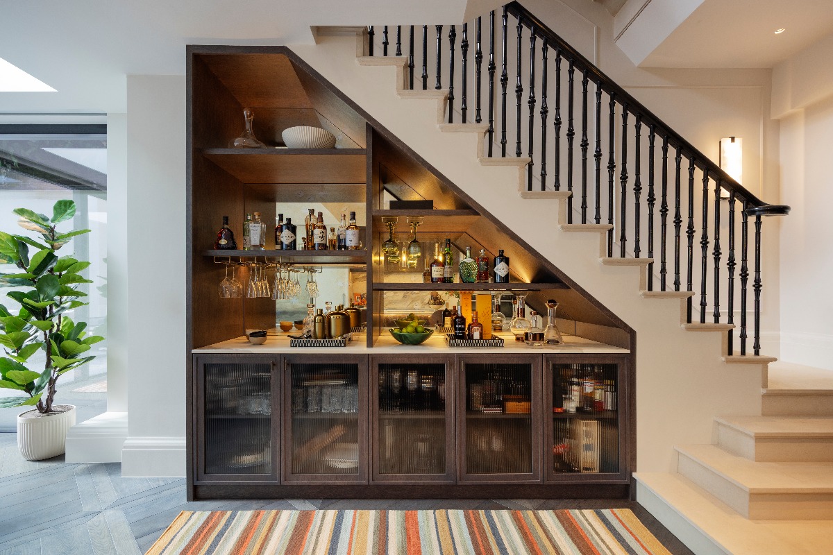 A home bar sitting under the stairs.