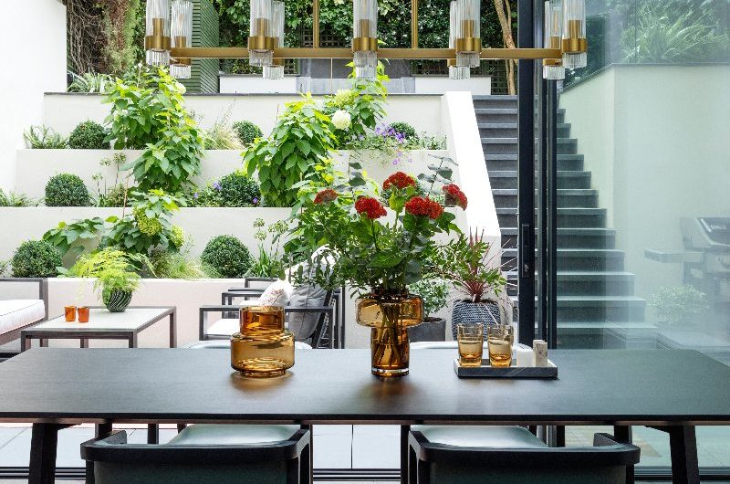 A dining zone looking out to the outdoor area and landscaping.