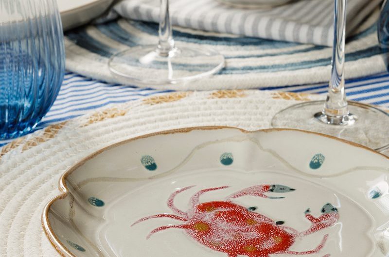 Closeup at a coastal-themed plate with fluted edges.