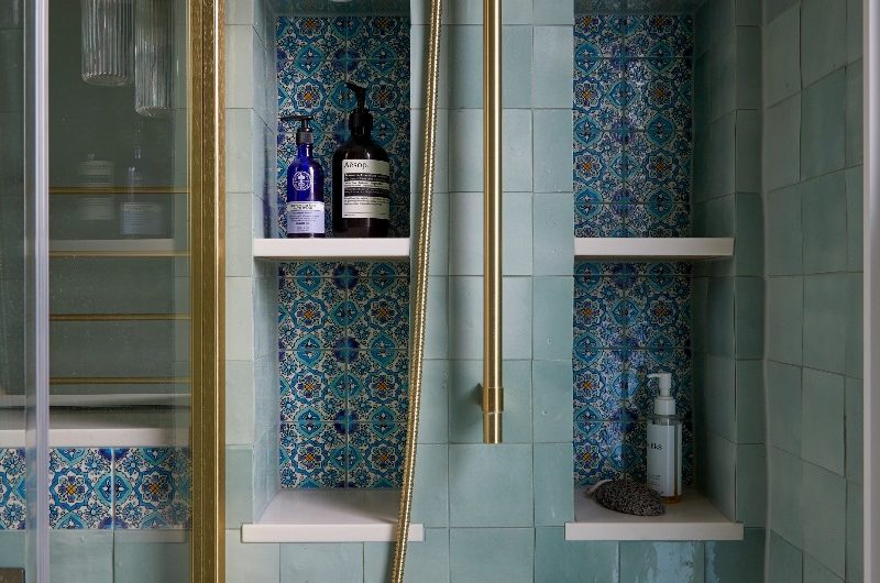 A stylish and colourful bathroom design with four patterned tiled niches in icy blue green zellige tiles.