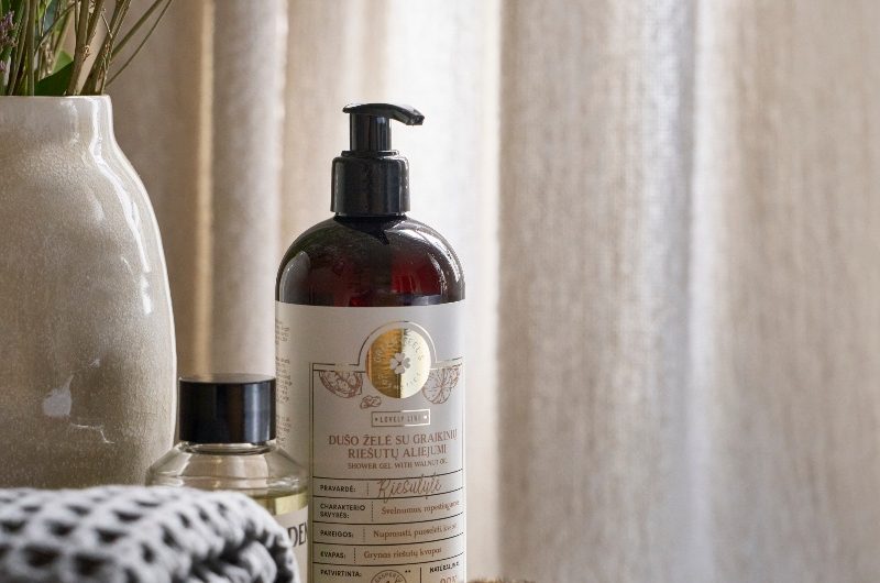 Toiletries on top of a wooden table in a luxury bathroom.