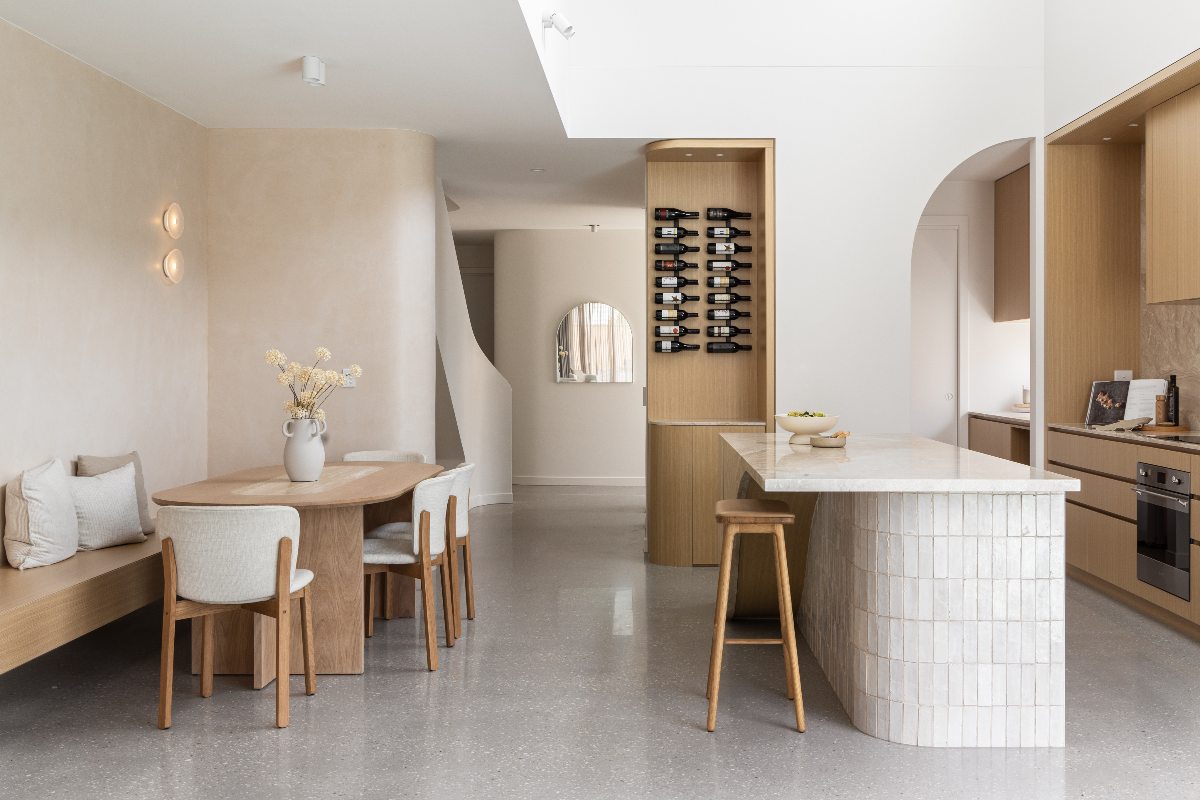 An open-plan space with an island and dining zone.