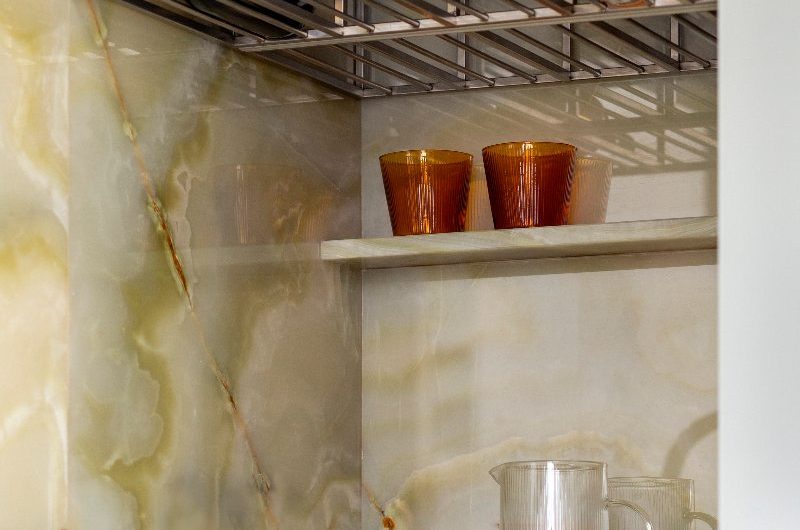 Coseup at a drinks zone with a steel bottle rack.