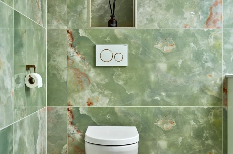 WC area in a charming green ensuite near the vanity.