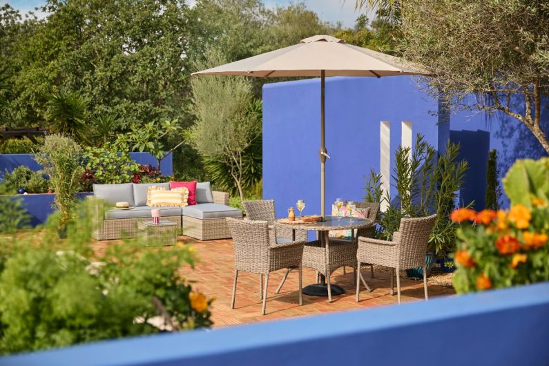 Colourful home with weaved seating solutions and an umbrella on a summer holiday.