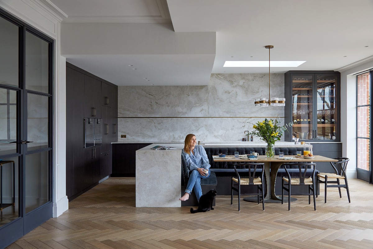 A luxurious kitchen design with classic contemporary style, statement surfaces, and dark cabinetry.