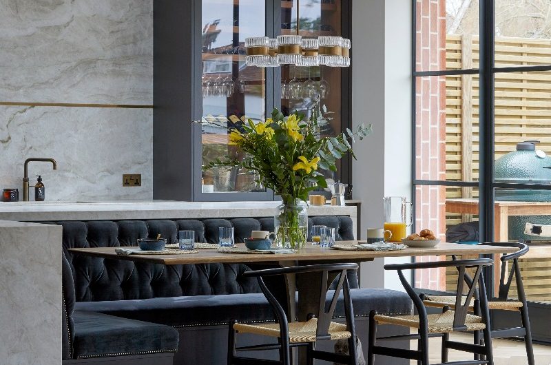 An L-shaped island with built-in seating and dining space.