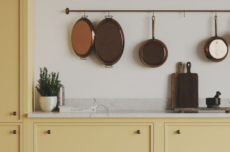 Pale yellow kitchen cabinetry with white paint and surfaces.