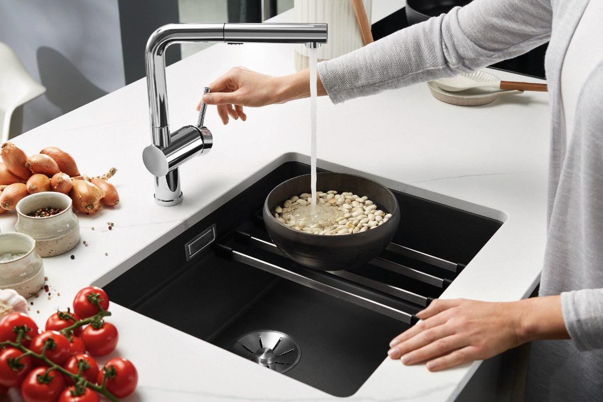 A sink with a rail for holding pans and steamers.
