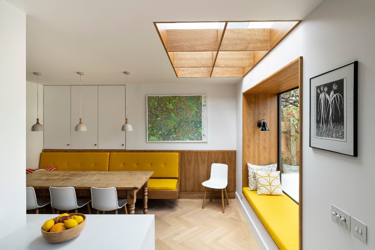 Dining area with a built-in bench, wood accents, and an oriel window.