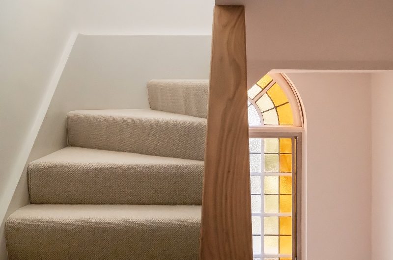 Stairwell with stained glass window.