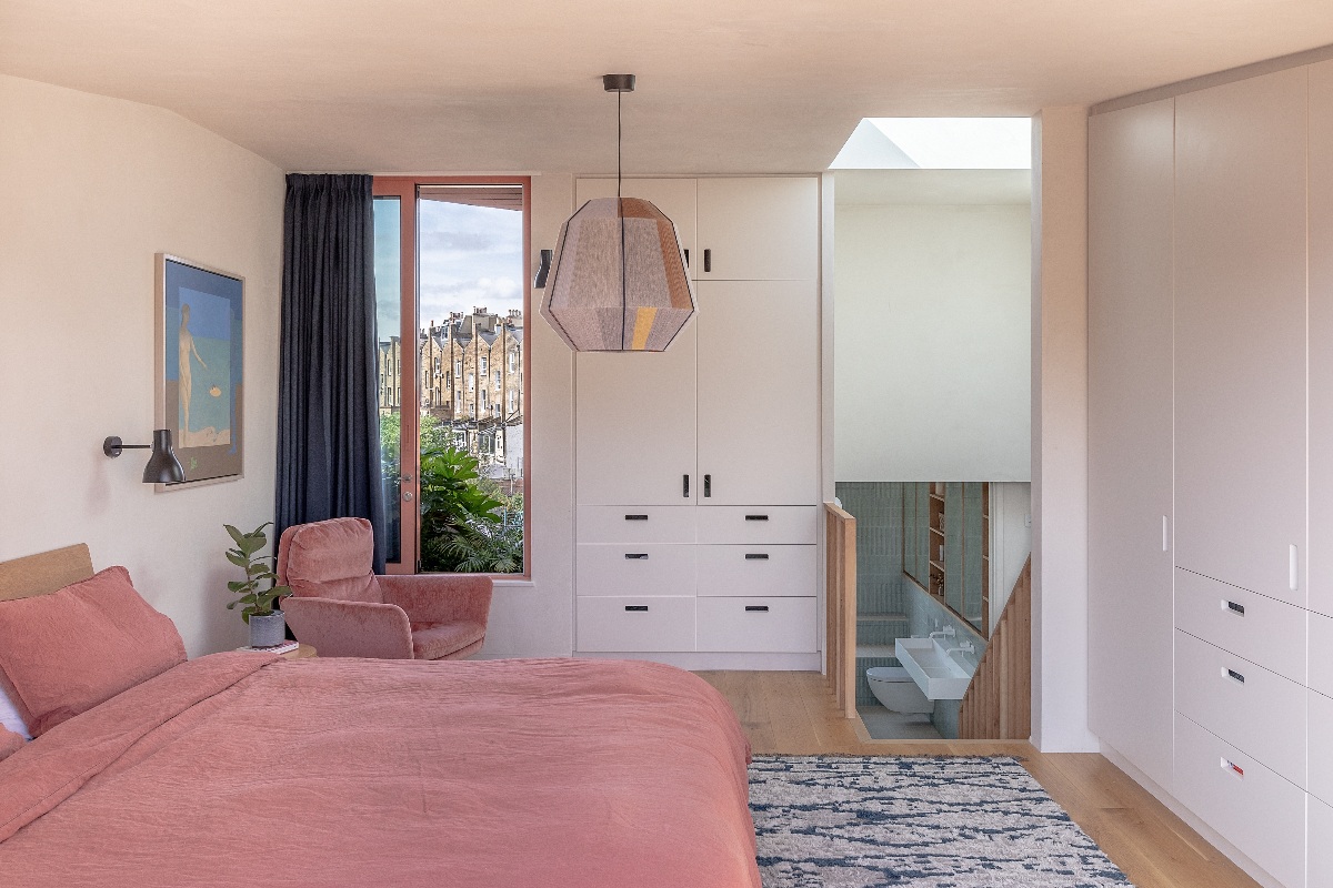 A loft bedroom with an adjoining ensuite, fitted wardrobes and glorious views.