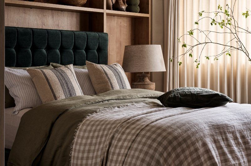 Neutral, nature-inspired scheme with wood furniture and open shelving, a green frame, airy curtains, and green linen.