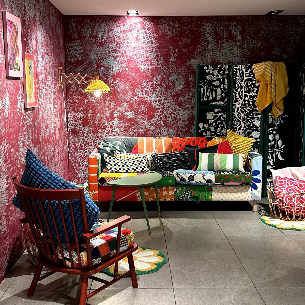 A interiors room set with colourful patterns, from the sofa to the cushions.