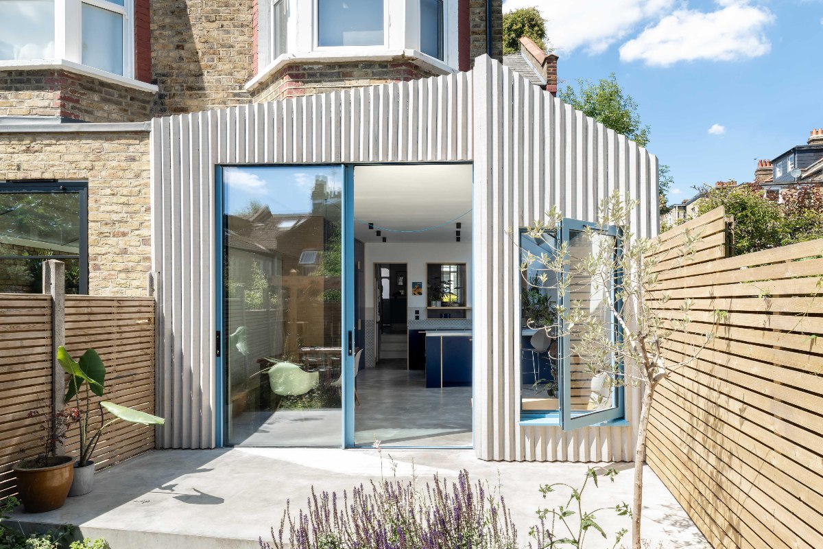 View of a kitchen extension clad in larch with texture.