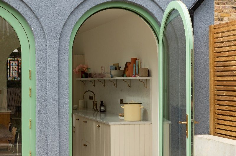 Outside view of the kitchen through an arched window.