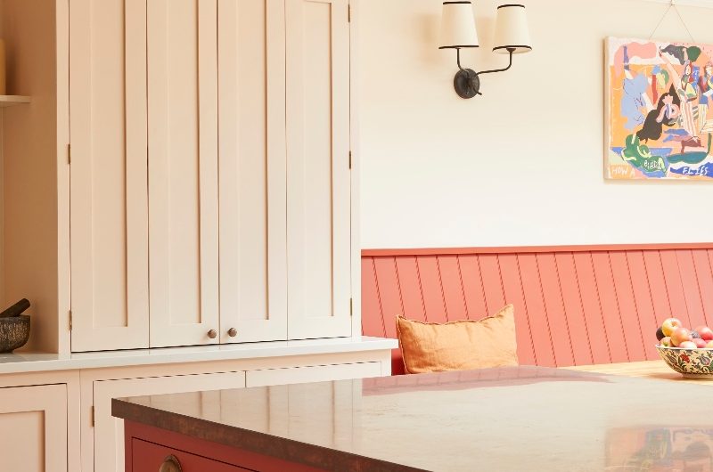 Kitchen design with a red island, blush cabinetry and matching walls and ceiling.
