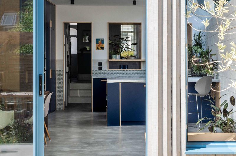 A blue kitchen design with an indoor-outdoor connection.