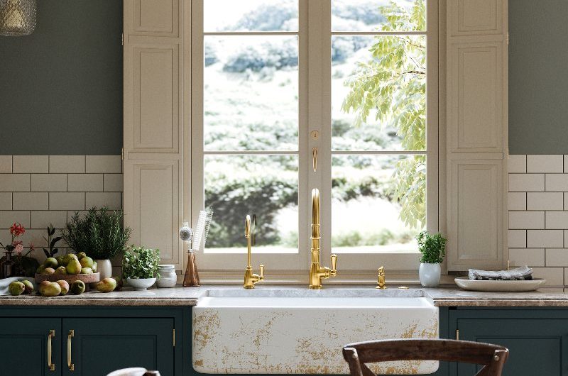 Classic kitchen design with a marble bowl sink, gold tap and a dining area.