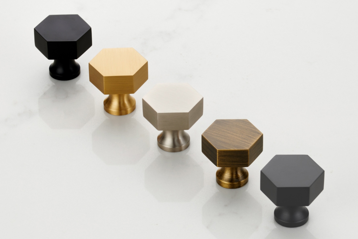 Small hexagonal door knobs in gold, silver, antique gold, and black finish.