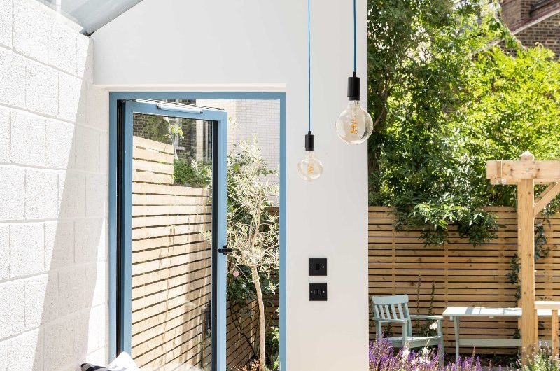 View of a window seat with painted frames looking into the garden.
