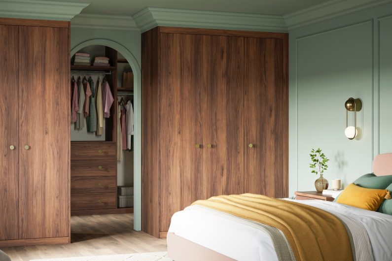 Green design with fitted wood wardrobes and a dressing area.