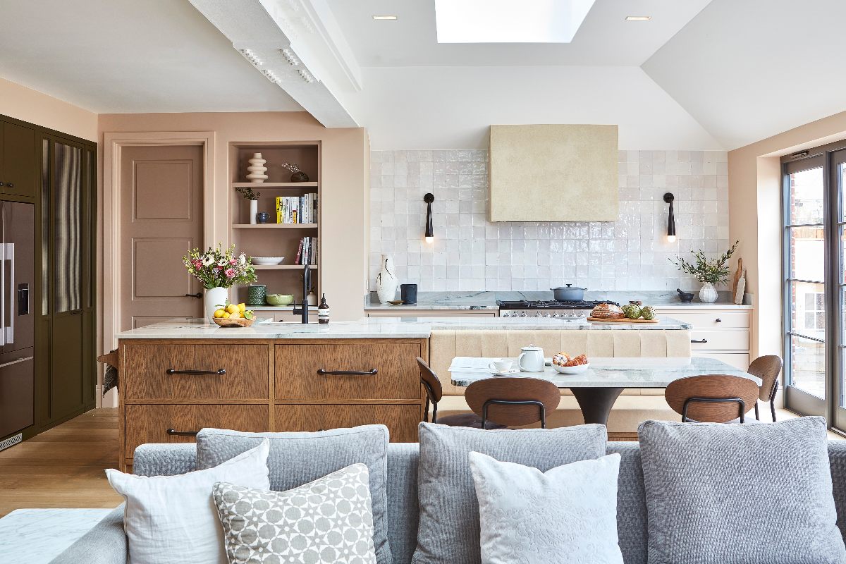 Modern design with neutral and wood cabinetry, zellige tiles, built-in shelving, and a dining area.