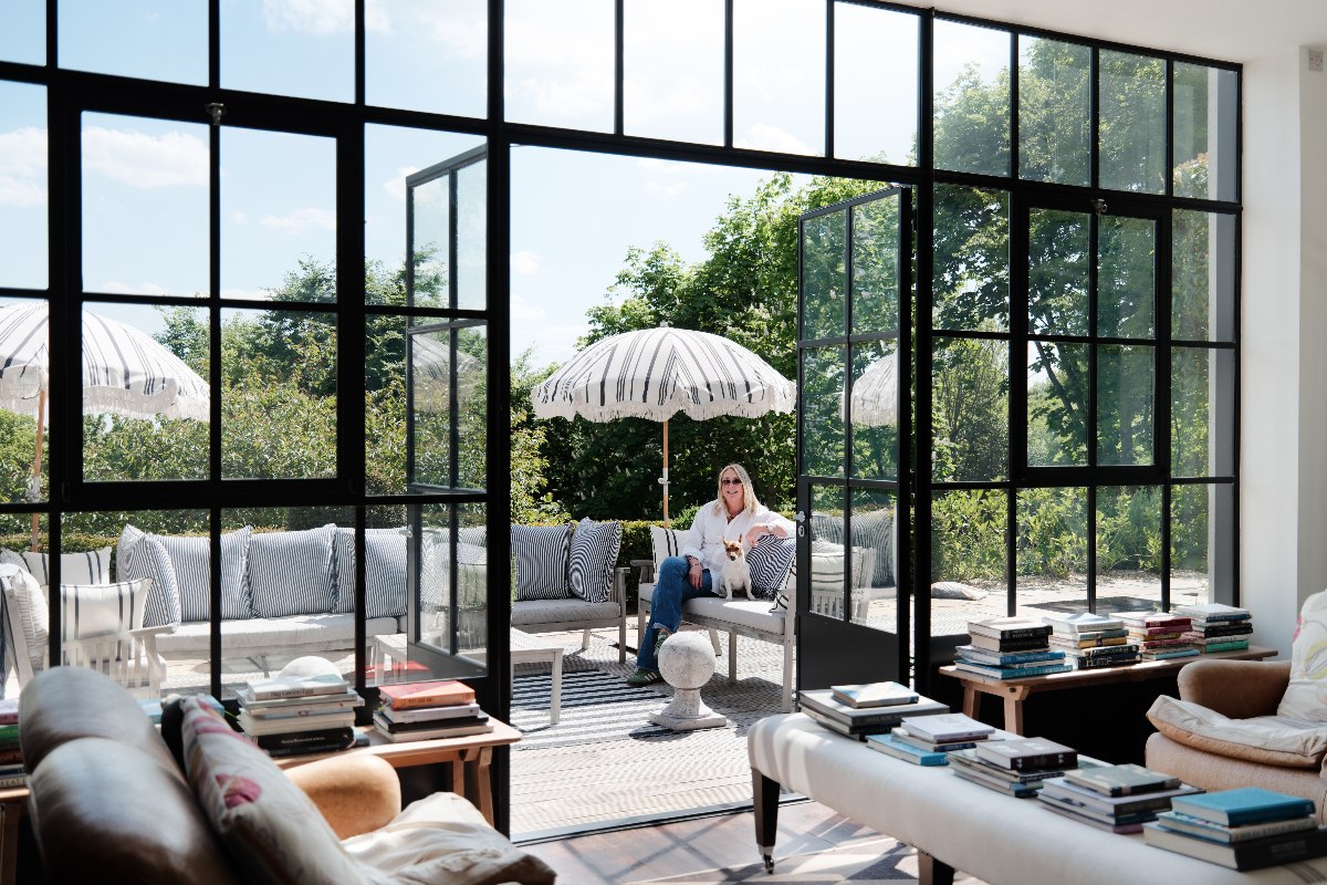 An outdoor terrace with seating and striped umbrellas.