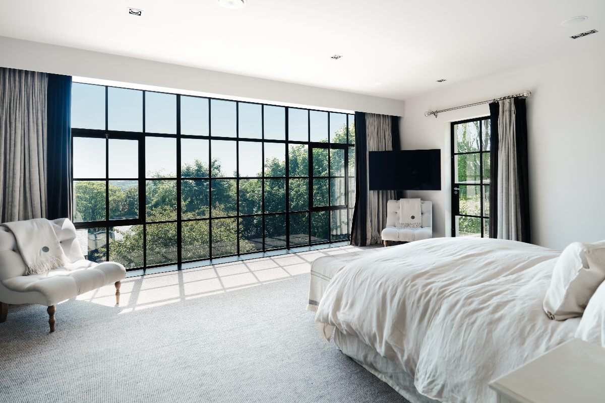 Calm and neutral bedroom design with Crittall windows.