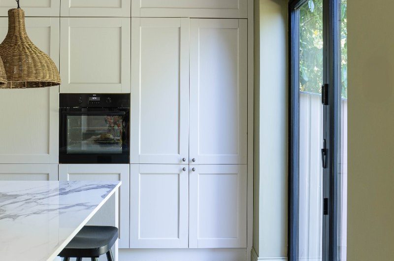 View of the cabinetry flooded with light through the glazing.