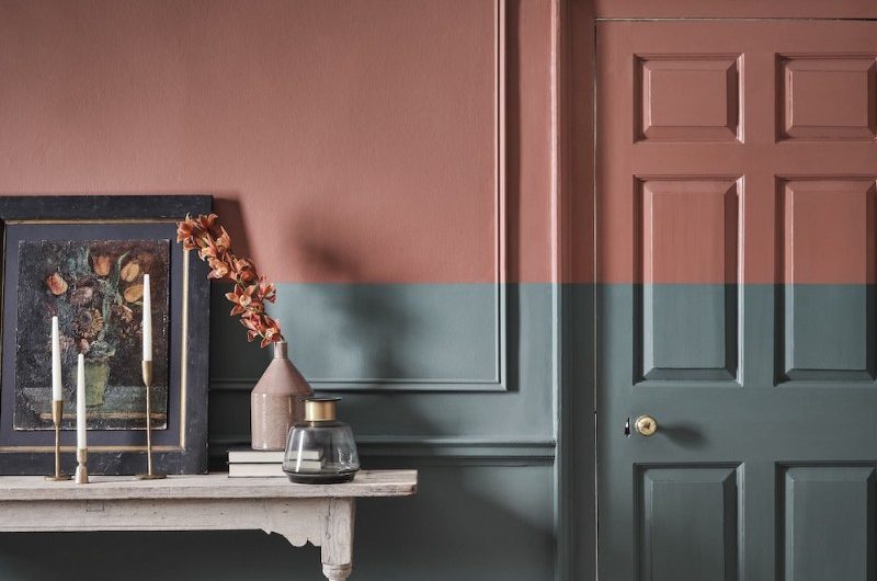 Bedroom design with a pale blue on the lower half of the walls and a muted rust colour on the upper half of the wall.