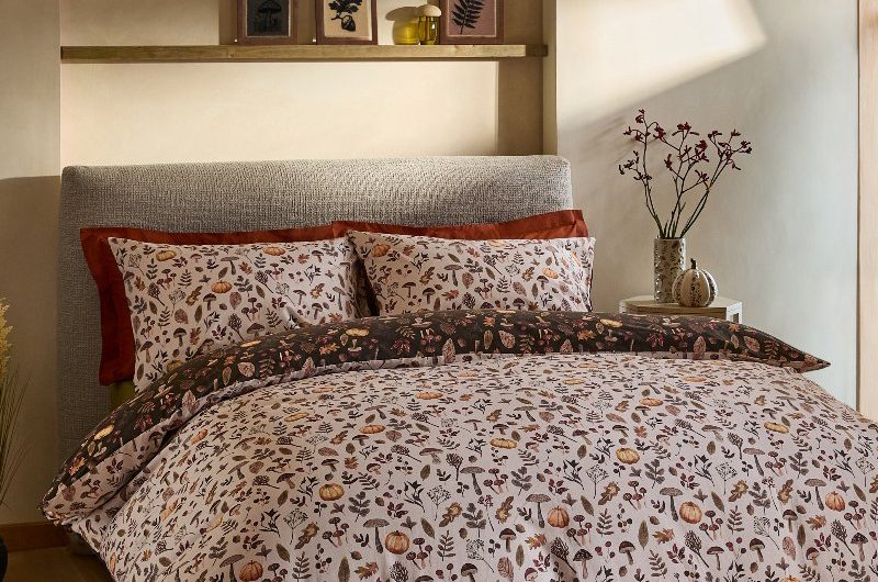 Rustic bedroom with pumpkin-patterned reversible bedding.