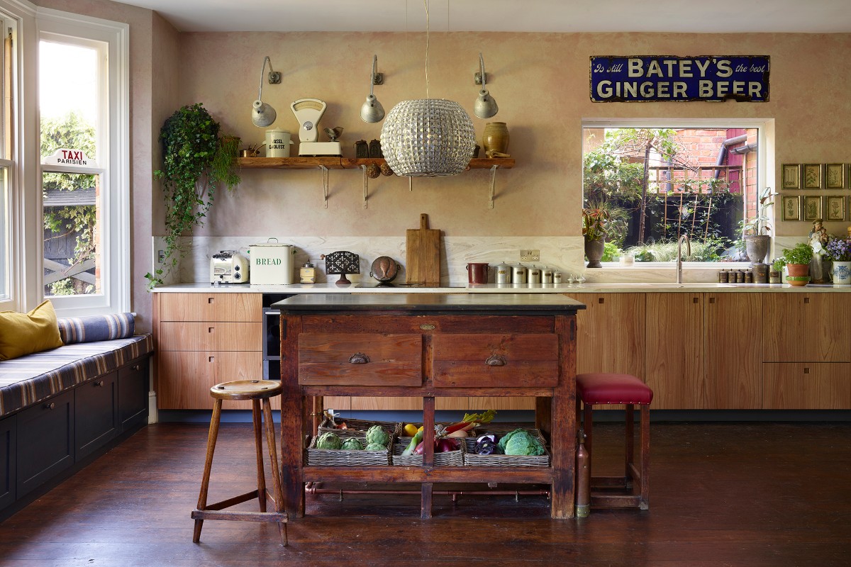 Wood kitchen with a vintage typesetting table as an island.