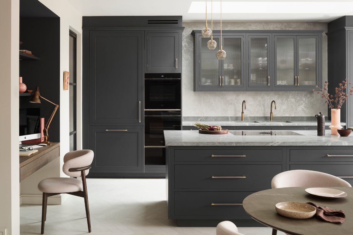 Modern space with an island, dining area and adjoining home office.