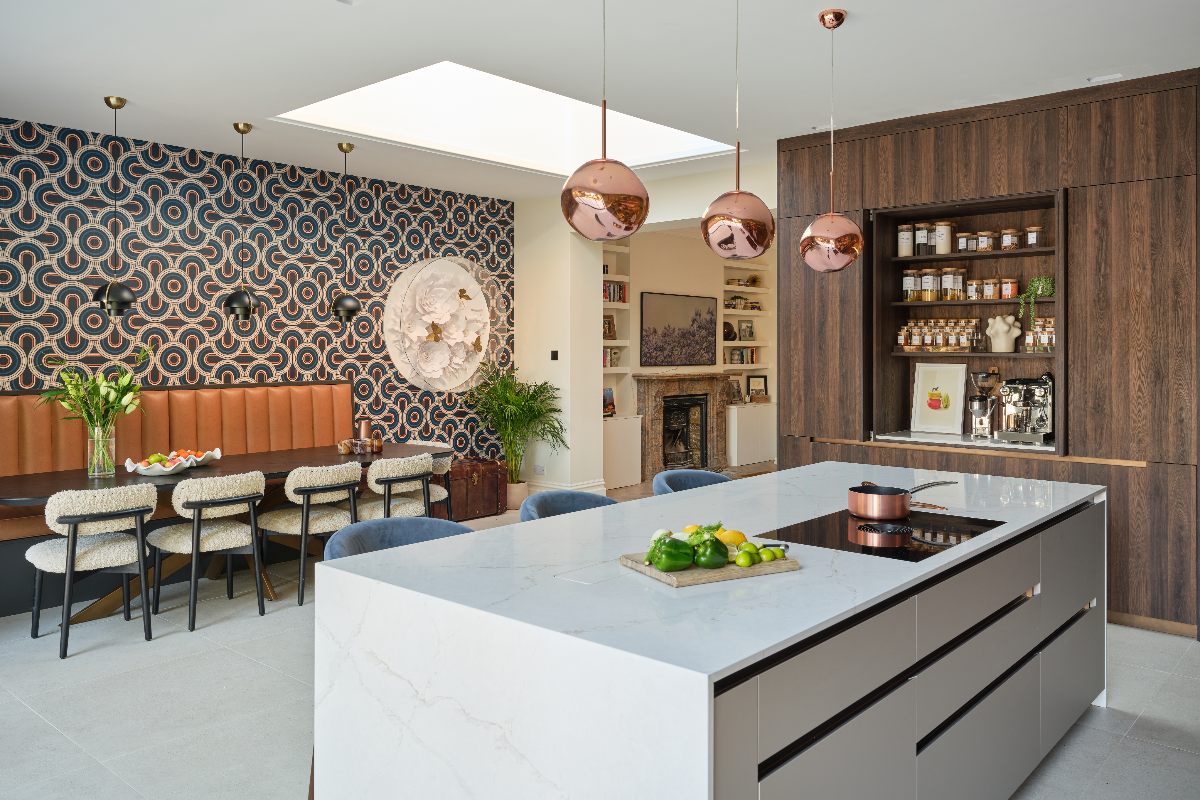 A kitchen with a large island and a retro dining area.