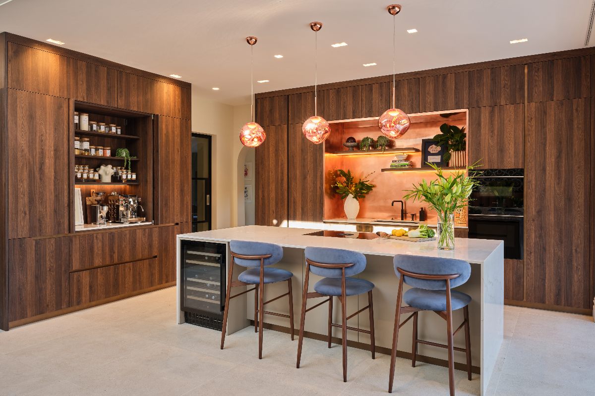 Wood cabinetry with a central island and layered lighting.