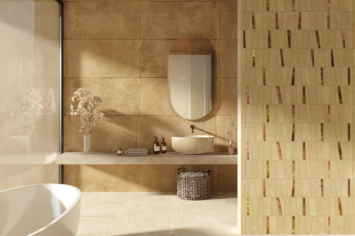 Bathroom design with large and small format tiles in neutral colours, a countertop basin with an oval mirror, and a freestanding tub.
