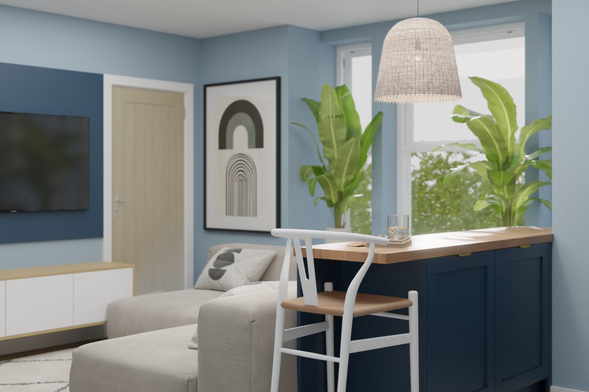 A seating area in the coastal kitchen with a media unit and wall art.