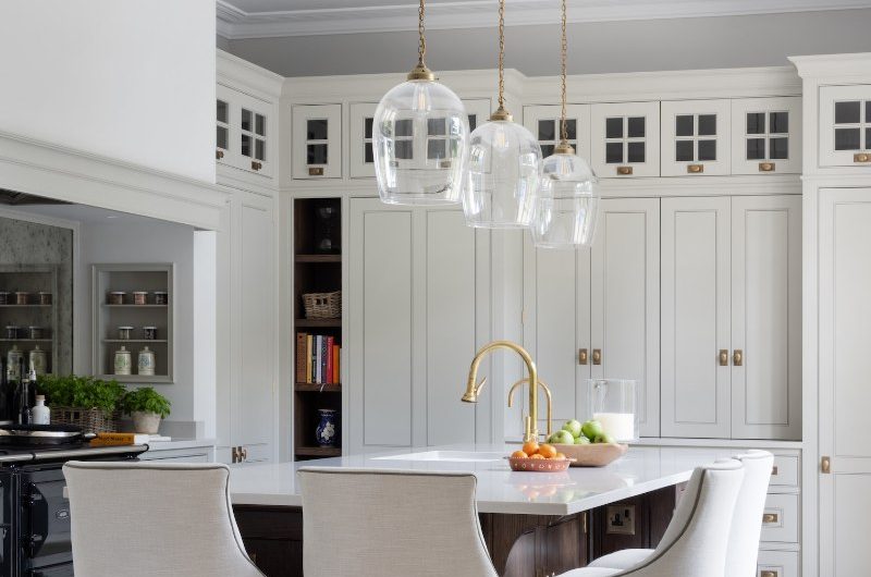 A classic scheme with bespoke cabinetry and a wood island with elegant chairs.
