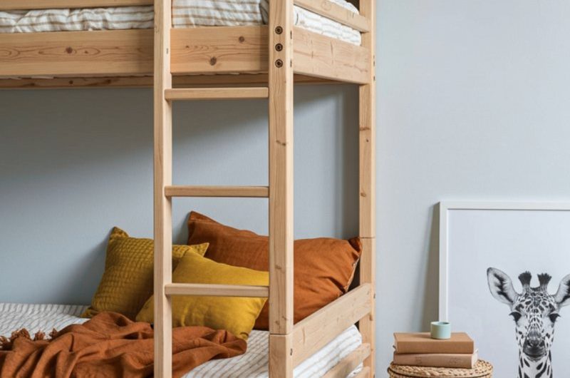 Pale blue bedroom with wood bunk beds and rattan decor.