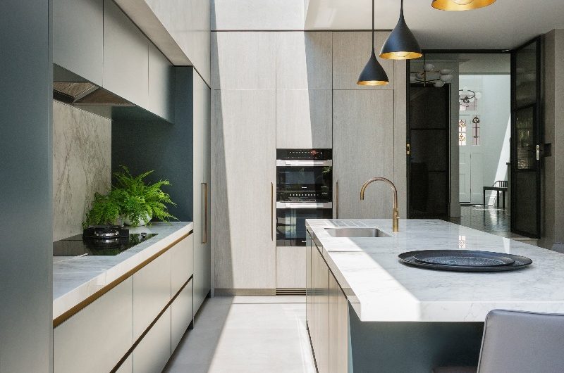 Modern kitchen with handleless units and a multi-functional island with a skylight above it.