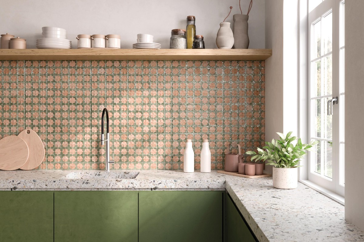 L-shaped cabinetry with terrazzo worktops and statement tile splashback with a wood shelf above.
