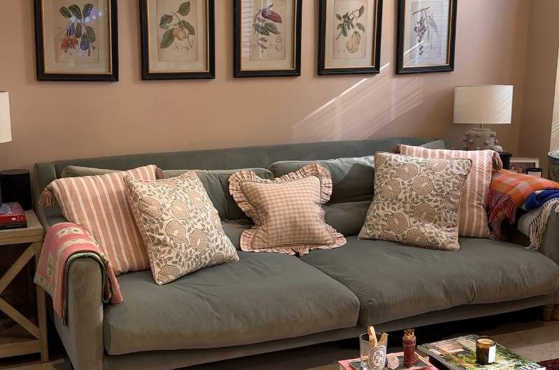 A living room renovation with a cosy sofa and styled ottoman.