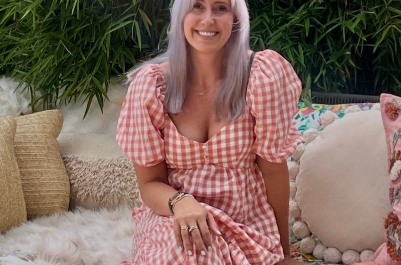 A homeowner posing in her garden.
