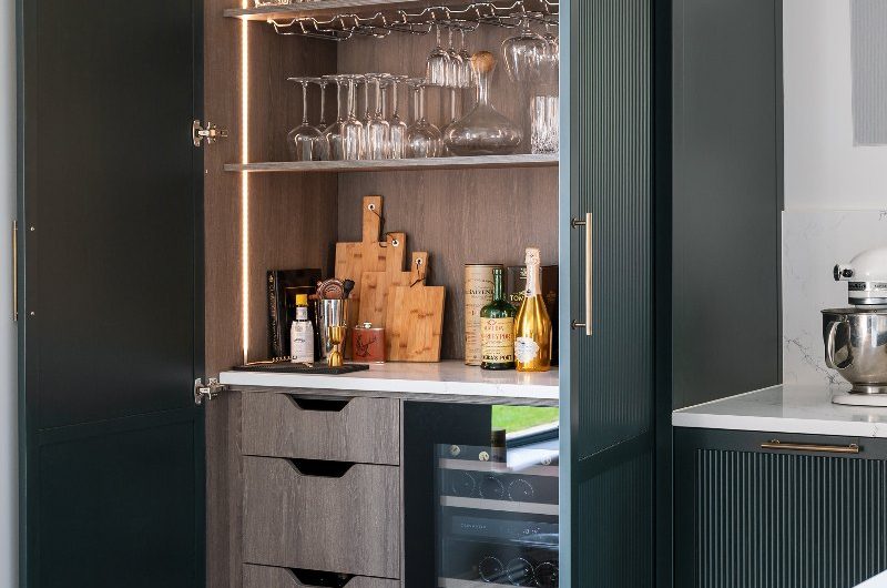 A bespoke bar with wine cooler, internal storage, and wine glass hanger.